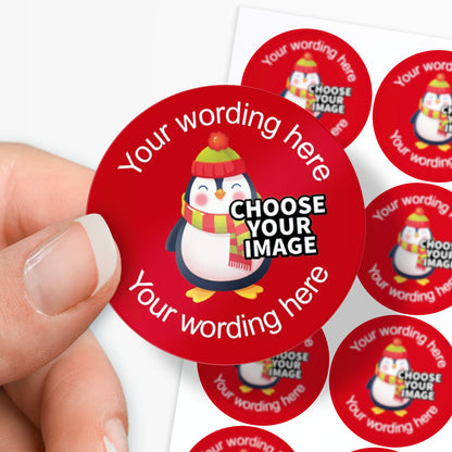 Red stickers with a penguin design and customisable text, held by a hand.