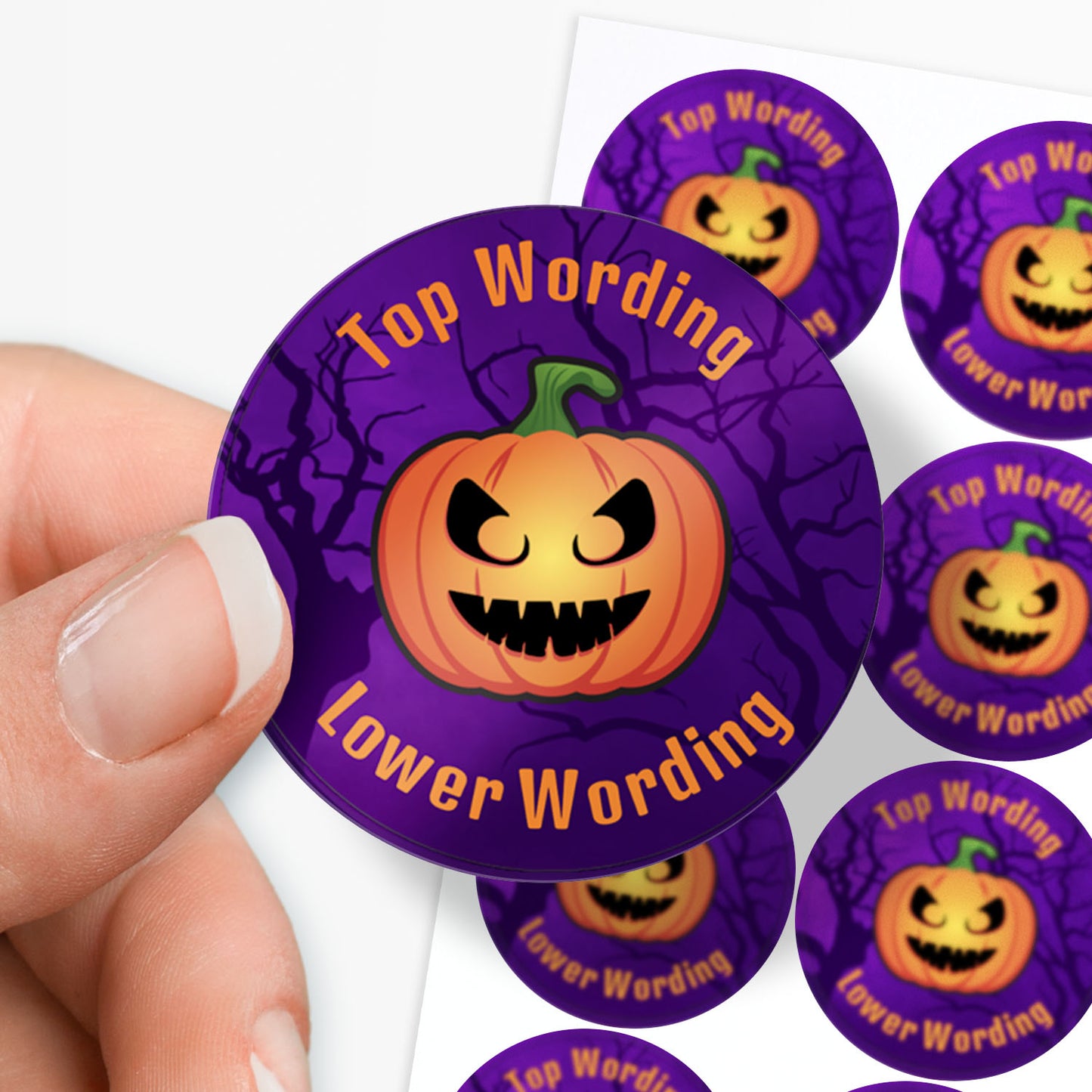Purple Halloween-themed stickers with pumpkin design held by a hand