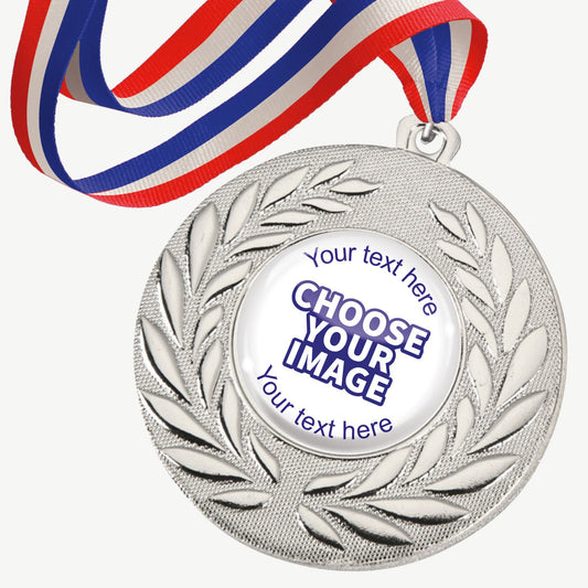 A set of ten silver-coloured metal medals, each featuring a central 25mm circular area for custom designs, encased in a clear, glossy dome; surrounded by a laurel wreath pattern and attached to a red, white and blue striped ribbon; designed for personalisation with text and images, ideal for sporting events and achievements.