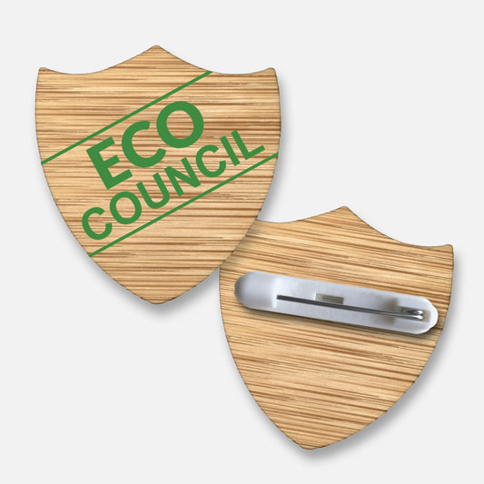 Shield-shaped 35mm bamboo badge with a natural wood grain finish, featuring the  text 'ECO COUNCIL' in green, bold uppercase letters; includes a metal pin fastening on the reverse, ideal for recognising pupils' contributions to environmental initiatives.