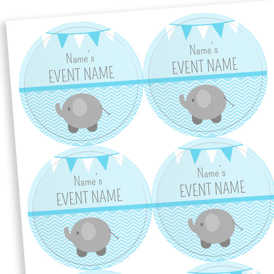 Sheet of round pale blue stickers with a line halfway down the sticker.  The bottom half shows a grey elephant against a wavy background.  Above the line placeholder text reading 'Name's    EVENT NAME' with two tone bunting at the top of the sticker.  Ideal for customisation for baby showers.