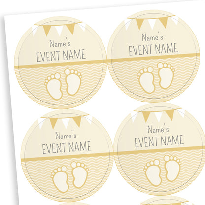 Sheet of round pale yellow stickers with a line halfway down the sticker.  The bottom half shows a pair of babies footprints against a wavy background.  Above the line placeholder text reading 'Name's    EVENT NAME' with two tone bunting at the top of the sticker.