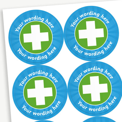 A sheet of customisable circular stickers featuring a cyan border and a green centre with a white first aid cross on it; includes customisable text above and below the image.