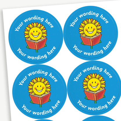 A sheet of blue stickers featuring a smiling sunflower reading a book in the centre.  Placeholder text 'Your wording here' is above and below the image for customisation.