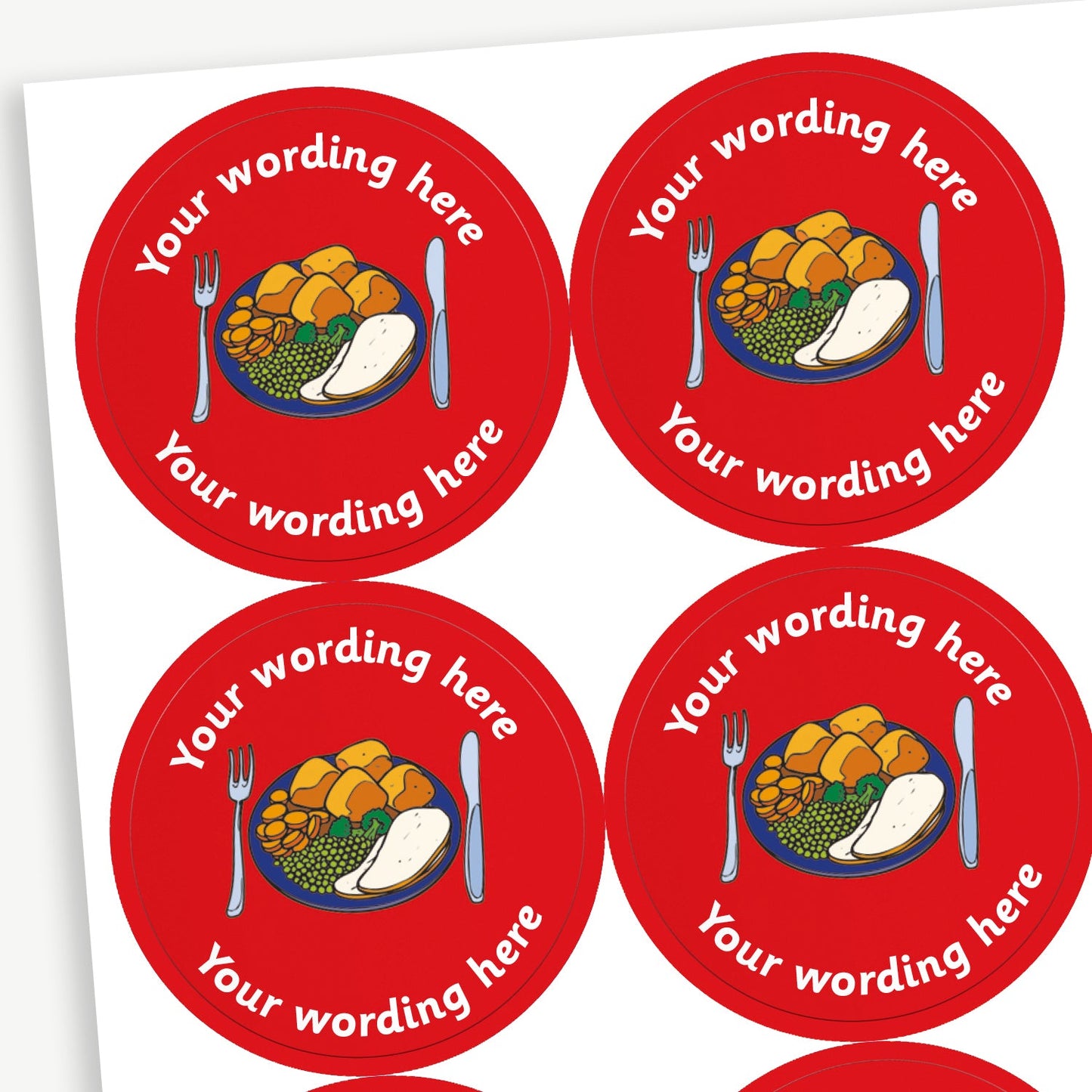 A sheet of circular reward stickers with a red background, each featuring a colourful illustration of a dinner plate with vegetables, potatoes with knife and fork. There is customisable text 'Your wording here' written in white above and below the image. 
