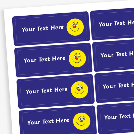 Sheet of rectangular dark blue stickers with white placeholder text reading 'Your Text Here'. Each sticker features a small illustration yellow smiling face with a red nose.