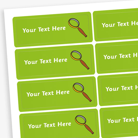 Sheet of rectangular green stickers with white placeholder text reading 'Your Text Here'. Each sticker features a small illustration of a magnifying glass.