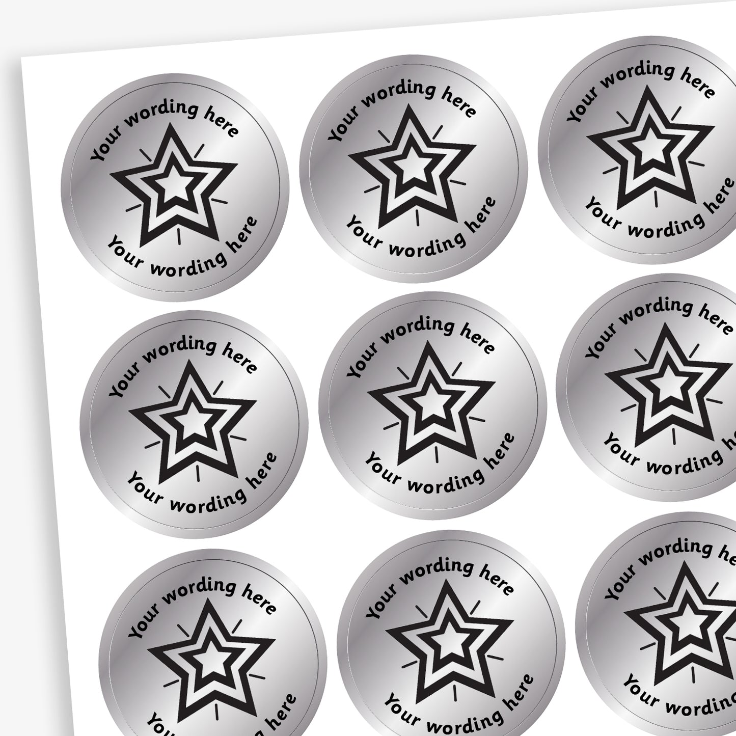 Sheet of 25mm round, metallic silver stickers, each featuring a bold black five-pointed star at the centre. Surrounding the star is placeholder text reading 'Your wording here' above and below, indicating customisable areas for personalised messages
