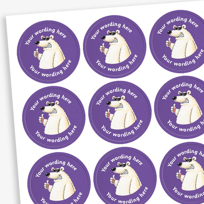 A sheet of purple circular stickers featuring a smiling polar bear, wearing sunglasses with a thumbs up; curving above and below the image is space for personalisation 'Your wording here' in a clear, bold font.