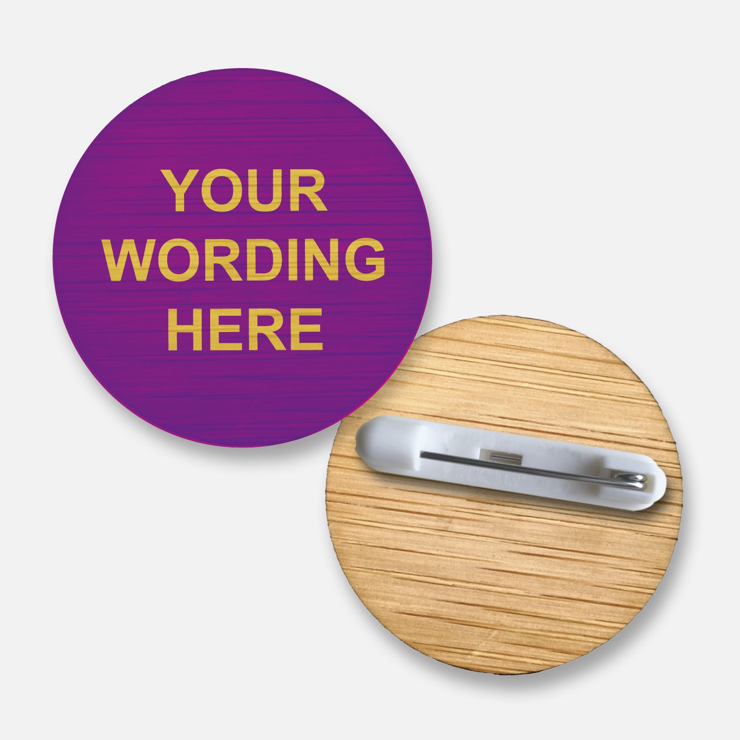 A 38mm circular badge crafted from natural bamboo coloured purple, featuring the placeholder text 'Your Wording Here' in yellow capital letters on the front, with a pin fastening on the reverse side.
