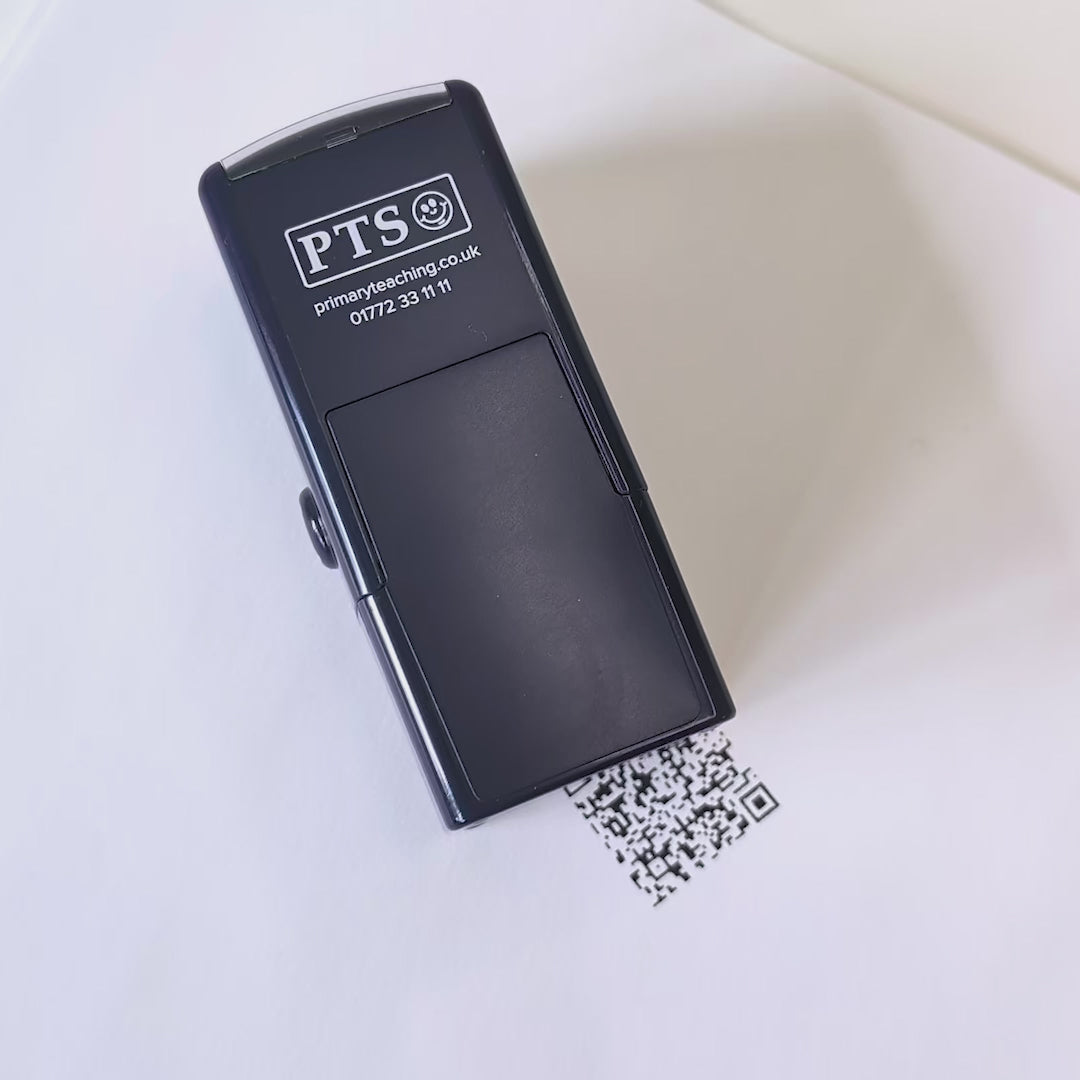 Custom QR code self-inking stamp shown stamping onto white paper.
