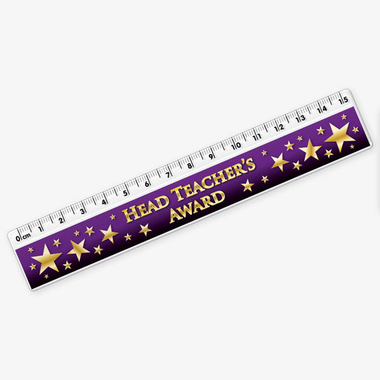 15cm ruler featuring a dark purple background with gold stars; and bold gold text reading 'Head Teacher's Award' along the centre.
