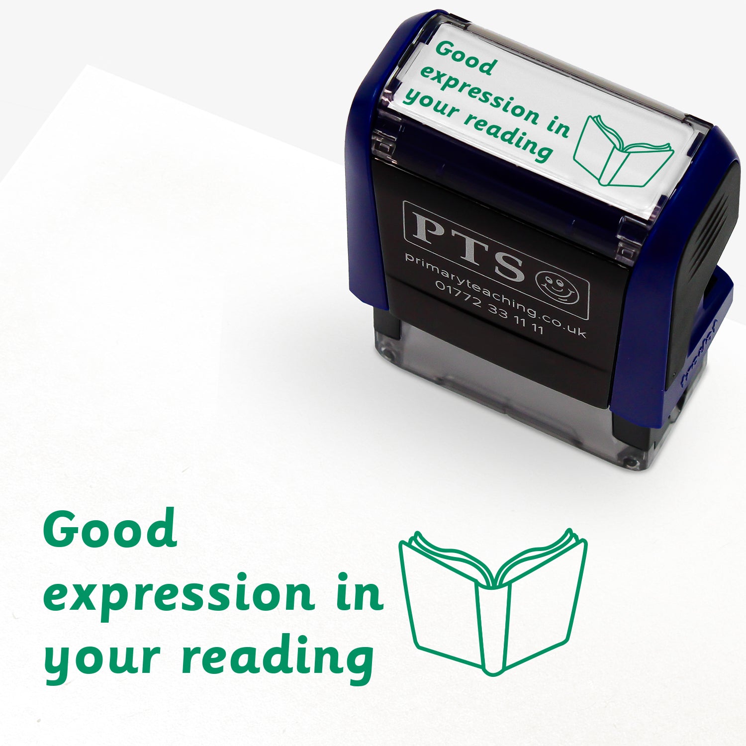 Rectangular self-inking stamper measuring 38mm by 15mm, featuring the phrase 'Good expression in your reading' in green text alongside an open book icon; available in green or purple ink, ideal for providing feedback in pupils' reading records and homework diaries.
