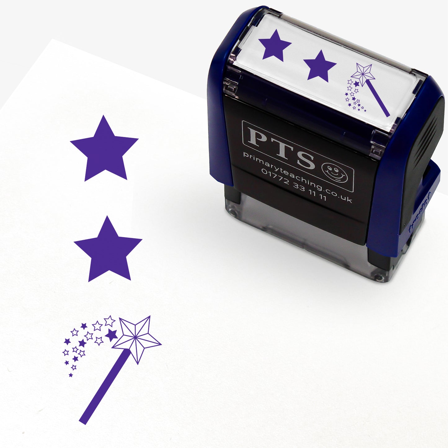 A rectangular pre-inked teacher stamper measuring 38mm x 15mm, featuring a purple vertical impression: a star at the top, a star in the middle and a wand with a shower of stars underneath.
