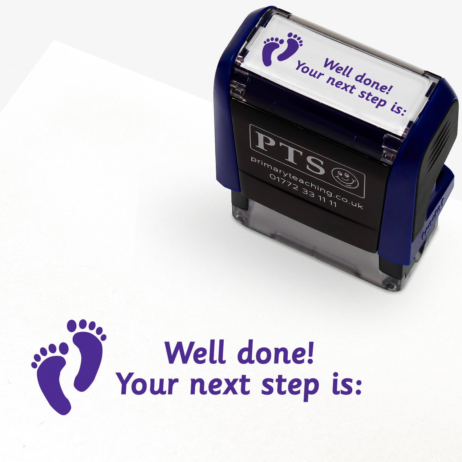 Rectangular self-inking stamper with purple ink, displaying a purple footprint icon alongside the text 'Well done! Your next step is:'; designed for marking and providing feedback in pupils' reading records and homework diaries.