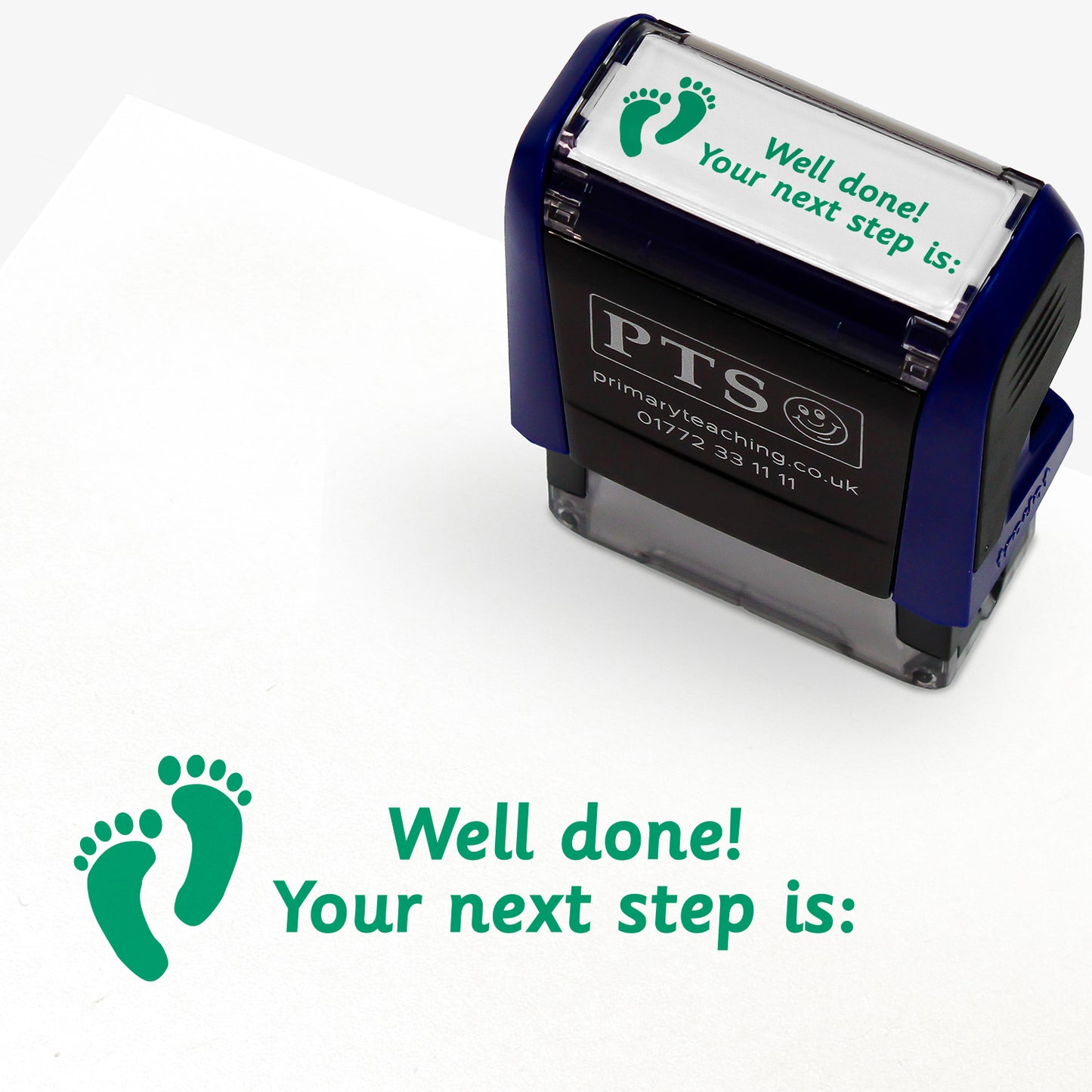 Rectangular self-inking stamper with green ink, displaying a green footprint icon alongside the text 'Well done! Your next step is:'; designed for marking and providing feedback in pupils' reading records and homework diaries.