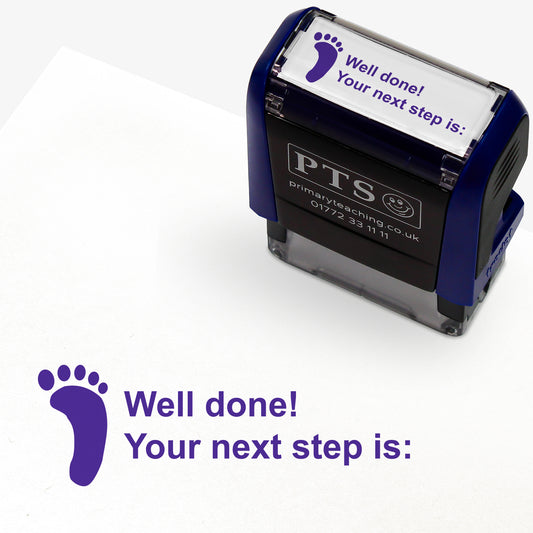 Rectangular self-inking stamper 38 x 15mm with purple ink, displaying a purple footprint icon alongside the text 'Well done! Your next step is:'; designed for marking and providing feedback in pupils' reading records and homework diaries.