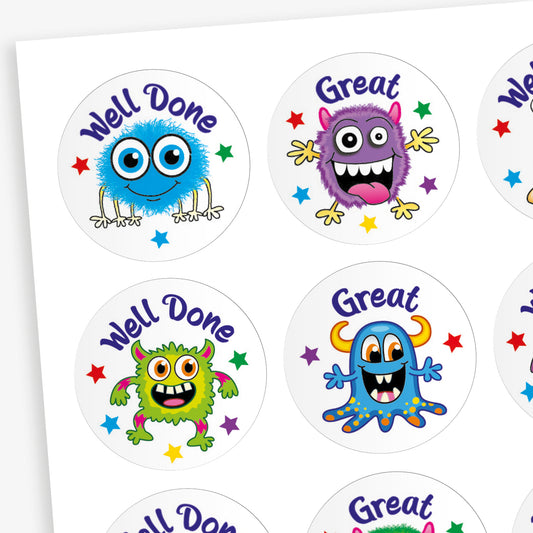 A sheet of 32mm circular stickers featuring colourful cartoon monsters with expressive faces, each accompanied by motivational phrases such as 'Well Done' and 'Great', designed to be berry-scented when rubbed.
