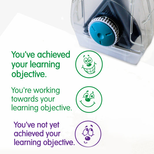 Complete Twist N Stamp.  Brick 1 Green ink -very happy face with phrase 'You've achieved your learning objective'.  Brick 2 green ink with smiling face and phrase 'You're working towards your learning objective'  Brick 3 in purple ink with unsure face and phrase 'You've not yet achieved your learning objective'.

