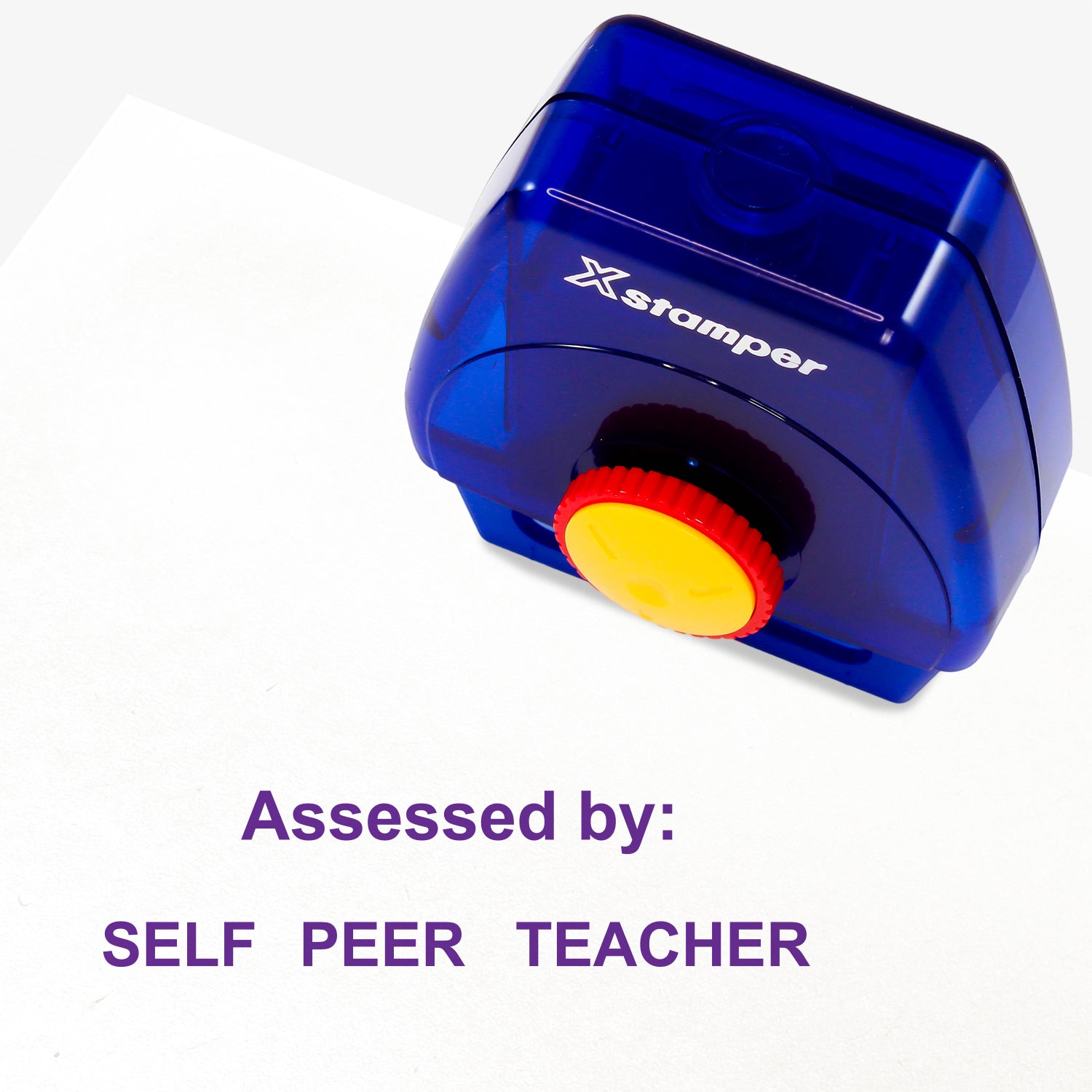 One Twist N Stamp brick in purple ink saying 'Assessed by:' and below the option to circle either 'SELF', 'PEER' or 'TEACHER'.  
